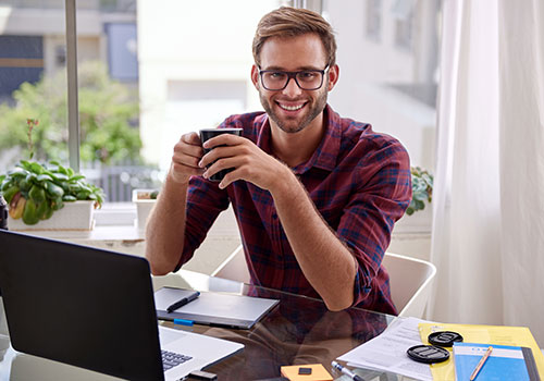 man at desk smiling